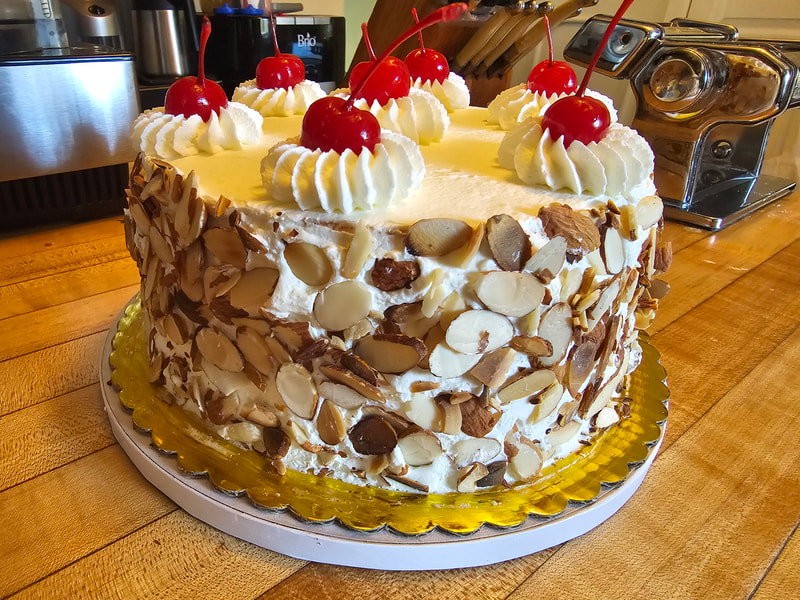 Italian Rum Cake
Italian, rum-soaked layer cake filled with velvety chocolate and vanilla pastry cream, Italian buttercream frosting and surrounded with sliced roasted almonds.